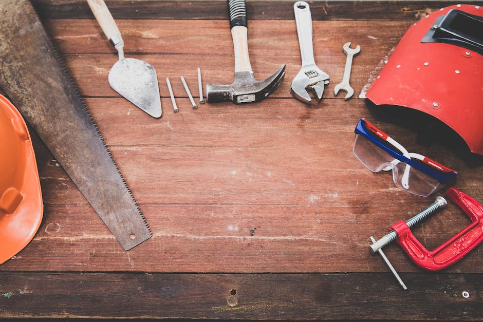 Image of a person repairing a laminate table top with the necessary tools and materials